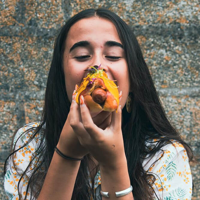 Woman Eating A Hot Dog